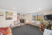 Home and income on 801m2 section, two separate three-bedroom dwellings on one title, each with its own driveway, currently rented for $1,030 per week, close to schools, golf club, shops, 18 Volante Avenue, Wattle Downs, Auckland