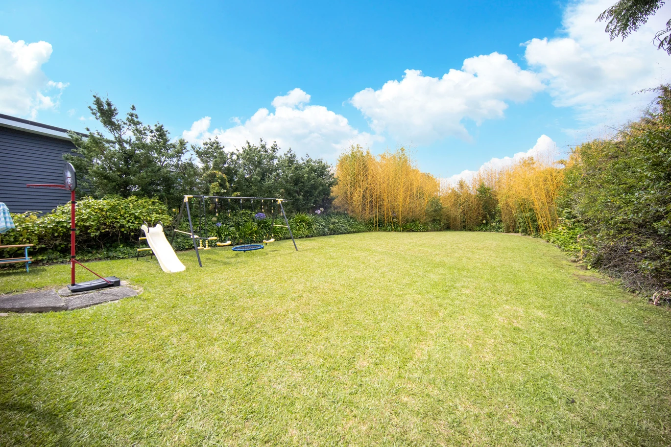 2 bed 1 bath house with garage on 809m2 section, The generous backyard provides plenty of room for kids to play, gardeners to potter, or future plans to unfold, 28 Norman Road, Titirangi, Auckland