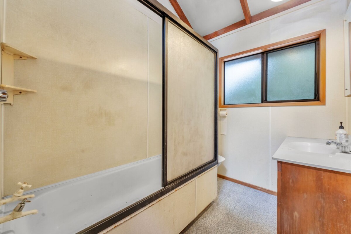 Once over 40 years, Owner Moved To Retirement Home, 221m2 4 beds 2 baths house with double garage on 1917m2 section, One of the decks enjoys glimpses of the sea, while the other sits just 30-40 metres from a magnificent, iconic Kauri tree, 58 Tainui Road, Titirangi, Auckland