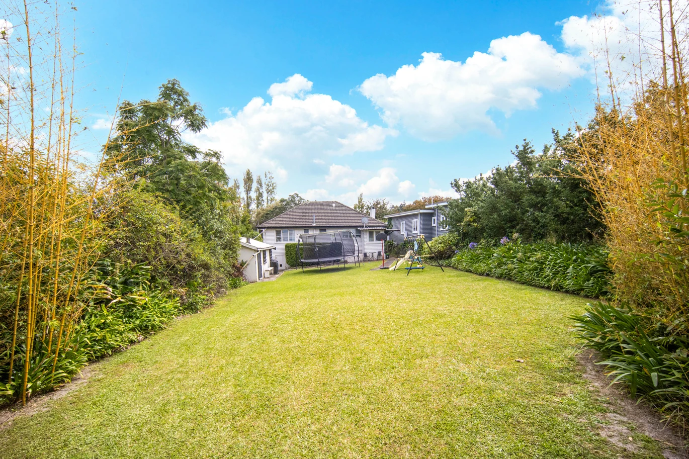 2 bed 1 bath house with garage on 809m2 section, The generous backyard provides plenty of room for kids to play, gardeners to potter, or future plans to unfold, 28 Norman Road, Titirangi, Auckland