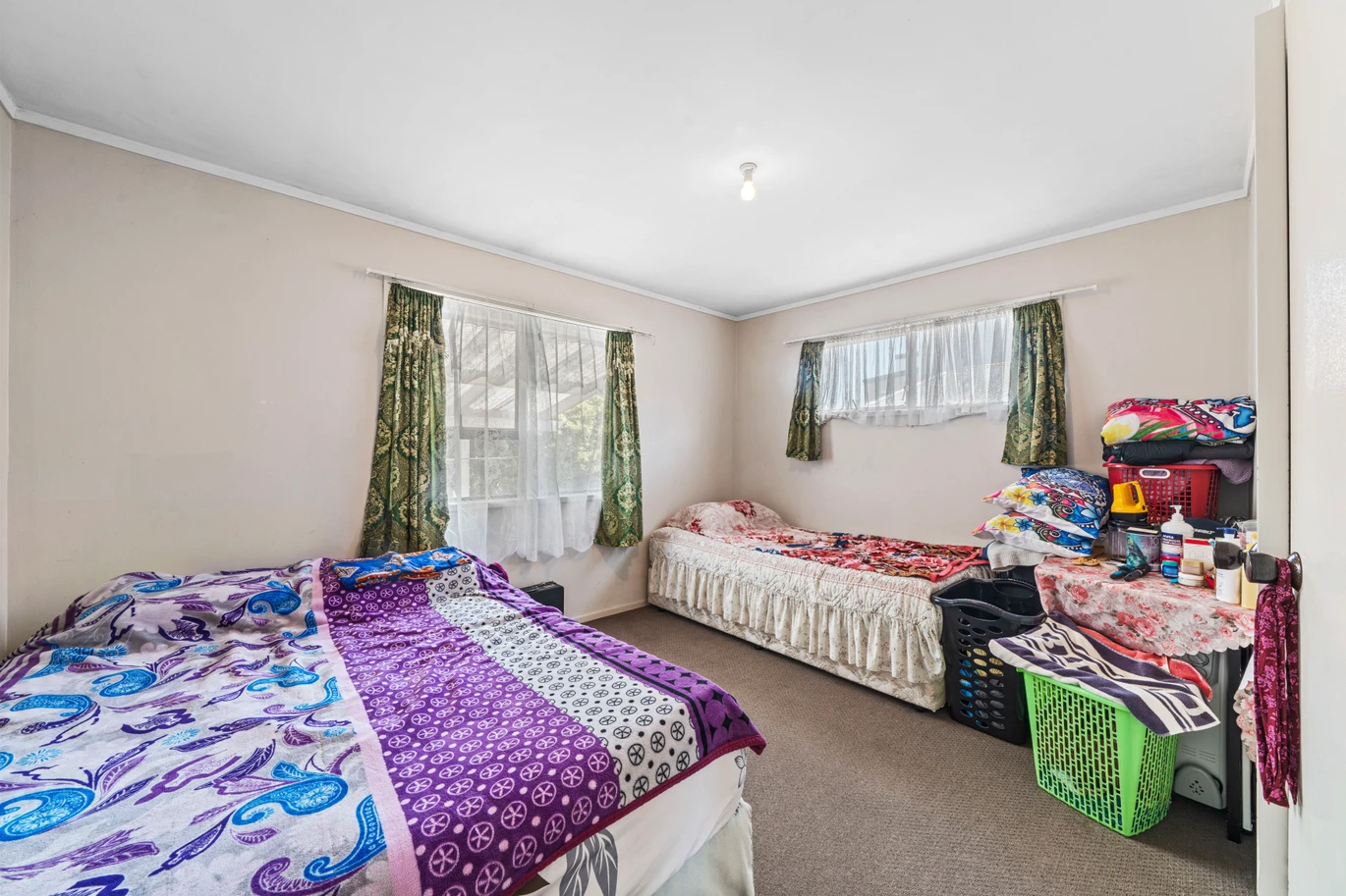 Home and income on 801m2 section, two separate three-bedroom dwellings on one title, each with its own driveway, currently rented for $1,030 per week, close to schools, golf club, shops, 18 Volante Avenue, Wattle Downs, Auckland