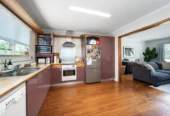 2 bed 1 bath house with garage on 809m2 section, The generous backyard provides plenty of room for kids to play, gardeners to potter, or future plans to unfold, 28 Norman Road, Titirangi, Auckland