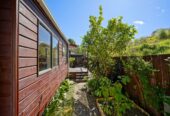 Backing directly onto Tui Glen Reserve, 3 beds 1 bath house with carport, just minutes from WestCity shopping centre, local cafes, schools, easy motorway access, 76B Chilcott Road, Henderson, Auckland