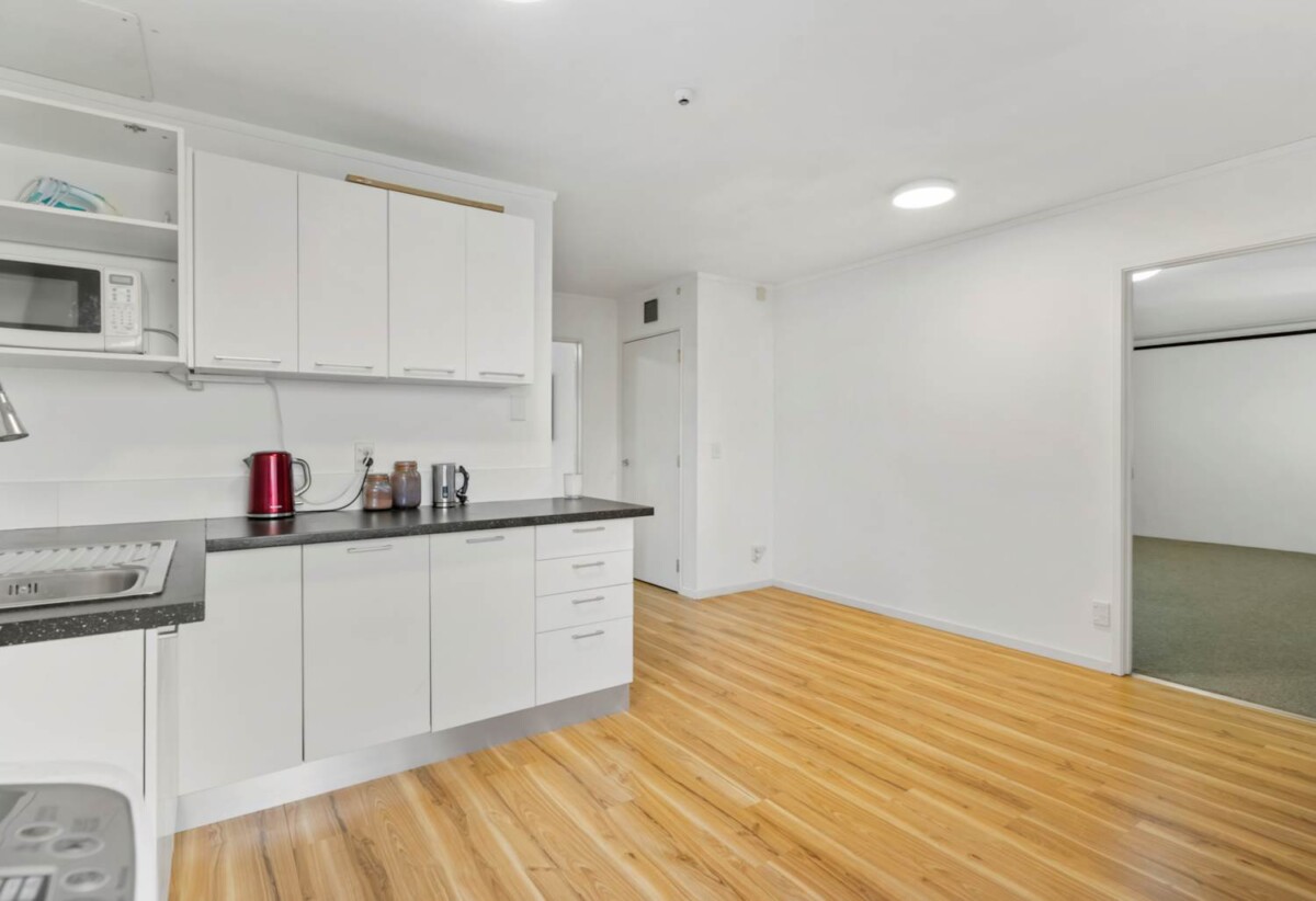 Rare Mixed-Use Opportunity, 98m2 upstairs 3 beds 1 bath apartment, 98m2 Flexible Commercial Space downstairs: 1 large office, 1 bath, Rear kitchenette area, Dedicated commercial entrance with courtyard patio, Additional large room with internal access to the double garage, Albany school zone, 15/18 Airborne Road, Rosedale, Auckland