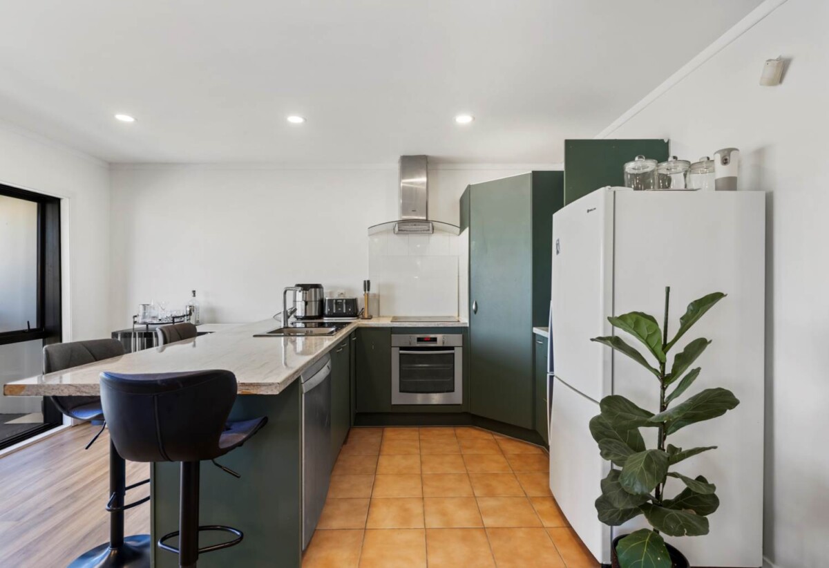Rare Mixed-Use Opportunity, 98m2 upstairs 3 beds 1 bath apartment, 98m2 Flexible Commercial Space downstairs: 1 large office, 1 bath, Rear kitchenette area, Dedicated commercial entrance with courtyard patio, Additional large room with internal access to the double garage, Albany school zone, 15/18 Airborne Road, Rosedale, Auckland