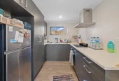 Home and income on 801m2 section, two separate three-bedroom dwellings on one title, each with its own driveway, currently rented for $1,030 per week, close to schools, golf club, shops, 18 Volante Avenue, Wattle Downs, Auckland