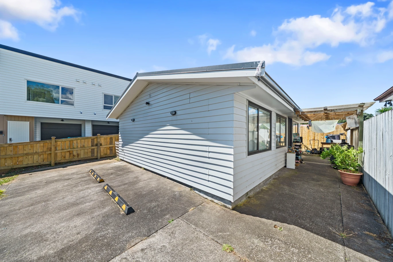 Home and income on 801m2 section, two separate three-bedroom dwellings on one title, each with its own driveway, currently rented for $1,030 per week, close to schools, golf club, shops, 18 Volante Avenue, Wattle Downs, Auckland