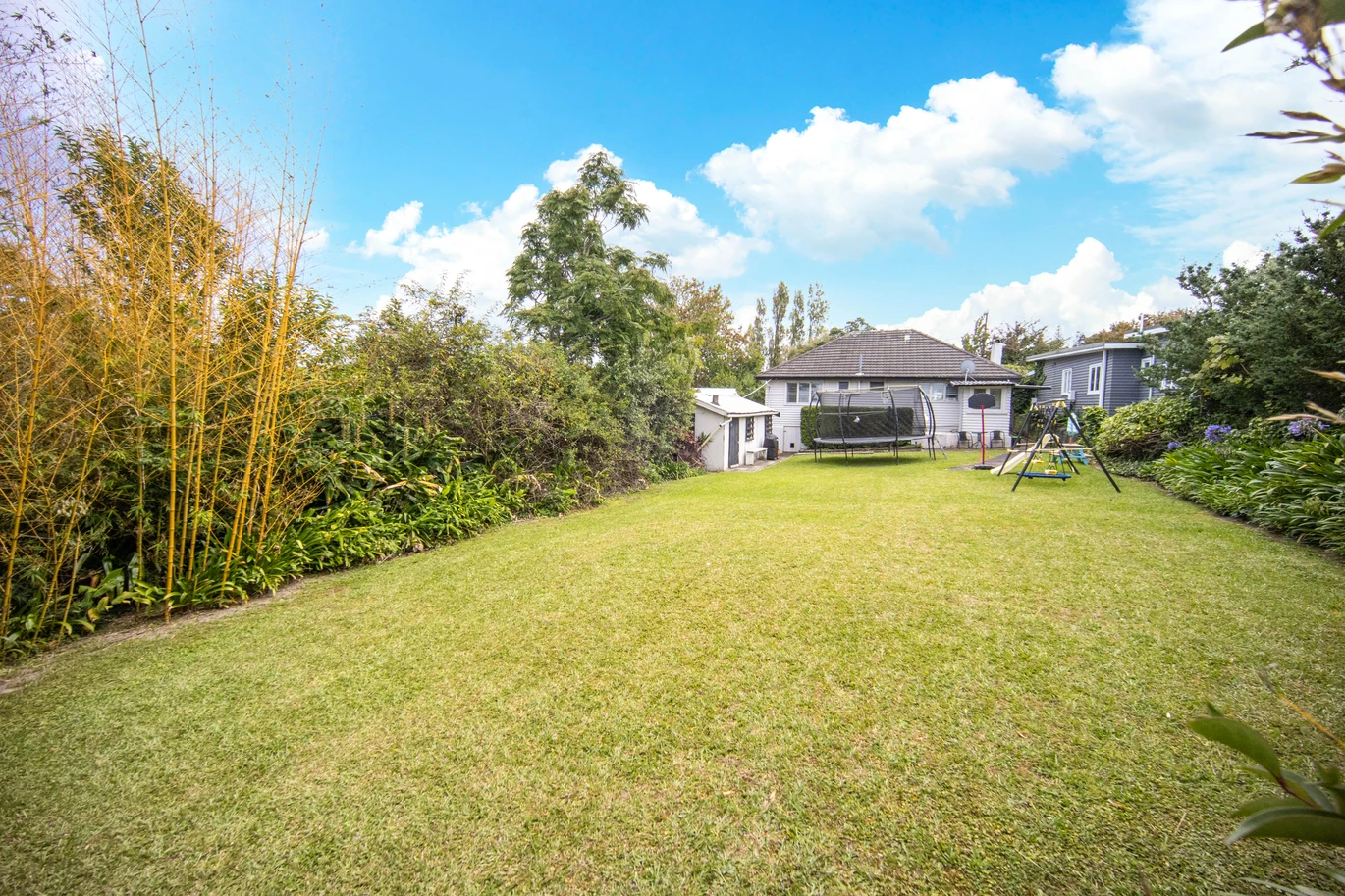 2 bed 1 bath house with garage on 809m2 section, The generous backyard provides plenty of room for kids to play, gardeners to potter, or future plans to unfold, 28 Norman Road, Titirangi, Auckland