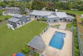 5052m2 section, 6 beds 4 baths ( 5 beds 3 baths triple garage main house + standalone 1 bed 1 bath kitchen, living and garage sleepout) house, with a heated swimming pool, Surrounded by established greenery, close to local amenities, schools, and motorway connections, 1.2 km to Alfriston College and Alfriston School, 21 Everlea Place, Alfriston, Auckland