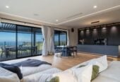 4 beds 3 baths house with double garage on 1897m2 section, A massive 180 m2 deck designed for legendary summer gatherings. Located in a secure, gated community, 3.4 km to Long Bay School, 11 Te Rata Road, Okura Bush, Auckland