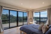 4 beds 3 baths house with double garage on 1897m2 section, A massive 180 m2 deck designed for legendary summer gatherings. Located in a secure, gated community, 3.4 km to Long Bay School, 11 Te Rata Road, Okura Bush, Auckland