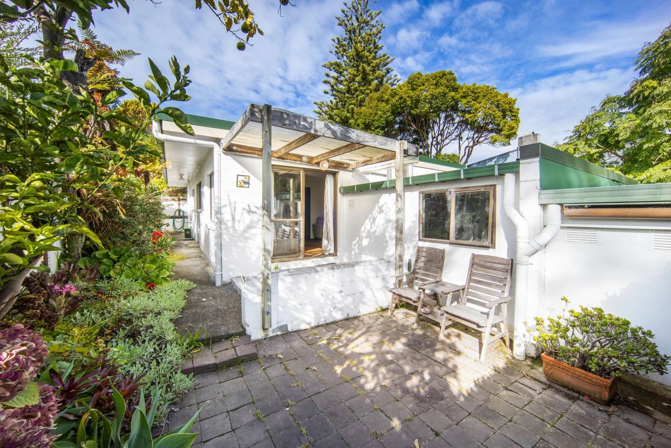 Once in 26 years, Constructed in block, 2 beds 1 bath home with garage, close to Green Bay Village, quality schooling, and public transport, With a park and playground just a short stroll away, 1/39 Cliff View Drive, Green Bay, Auckland
