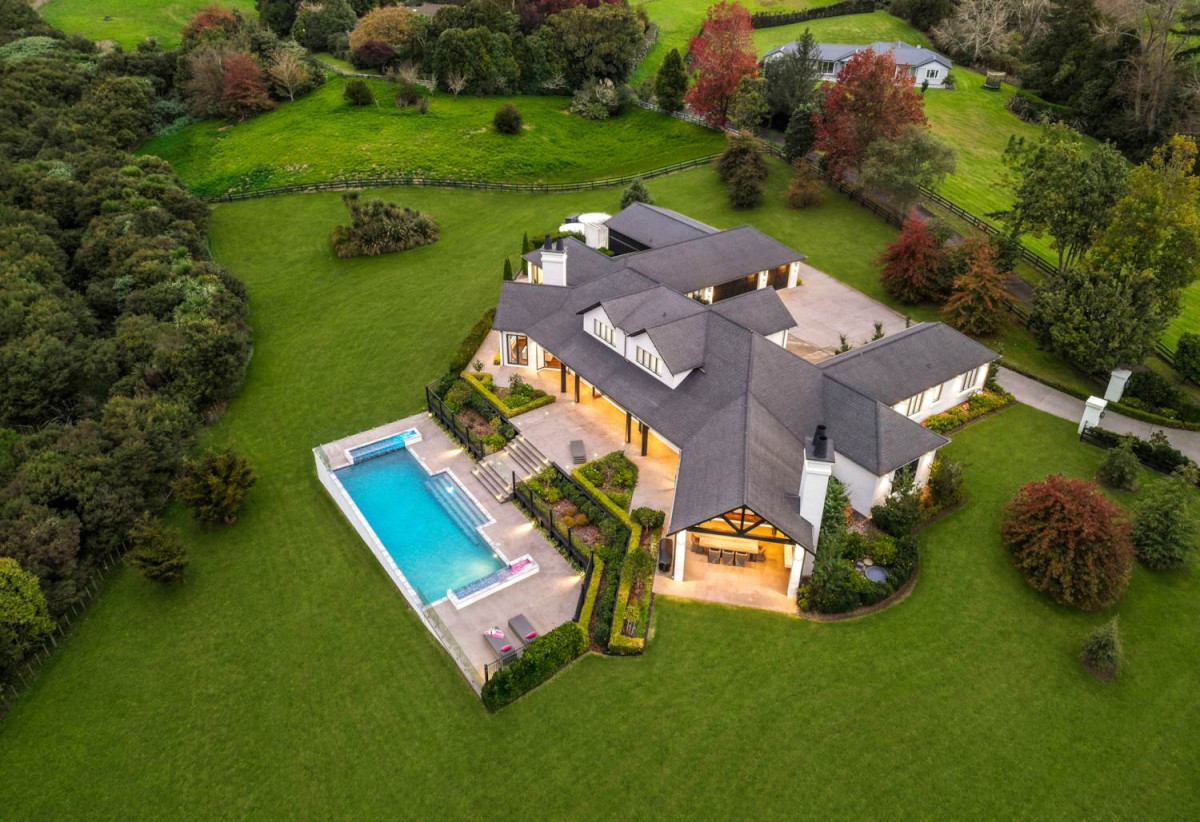 30,269m² section, The home offers 5 beds 3 baths, including a private guest suite with a designer ensuite featuring dual showers, A separate wing accommodates additional bedrooms and a luxurious family bathroom with a sculptural real stone bath, Underfloor heating throughout, A five-car garage, A formal 10-seater dining room beneath a genuine Swarovski crystal chandelier, integrated throughout the home is a premium HEOS multi-room audio system, a fully equipped private cinema with six luxury seats, The stunning 16.5-metre heated swimming pool (approx. 5.5–6m wide), 2.2 km to Riverhead School, 739 Coatesville-Riverhead Highway, Riverhead, Auckland
