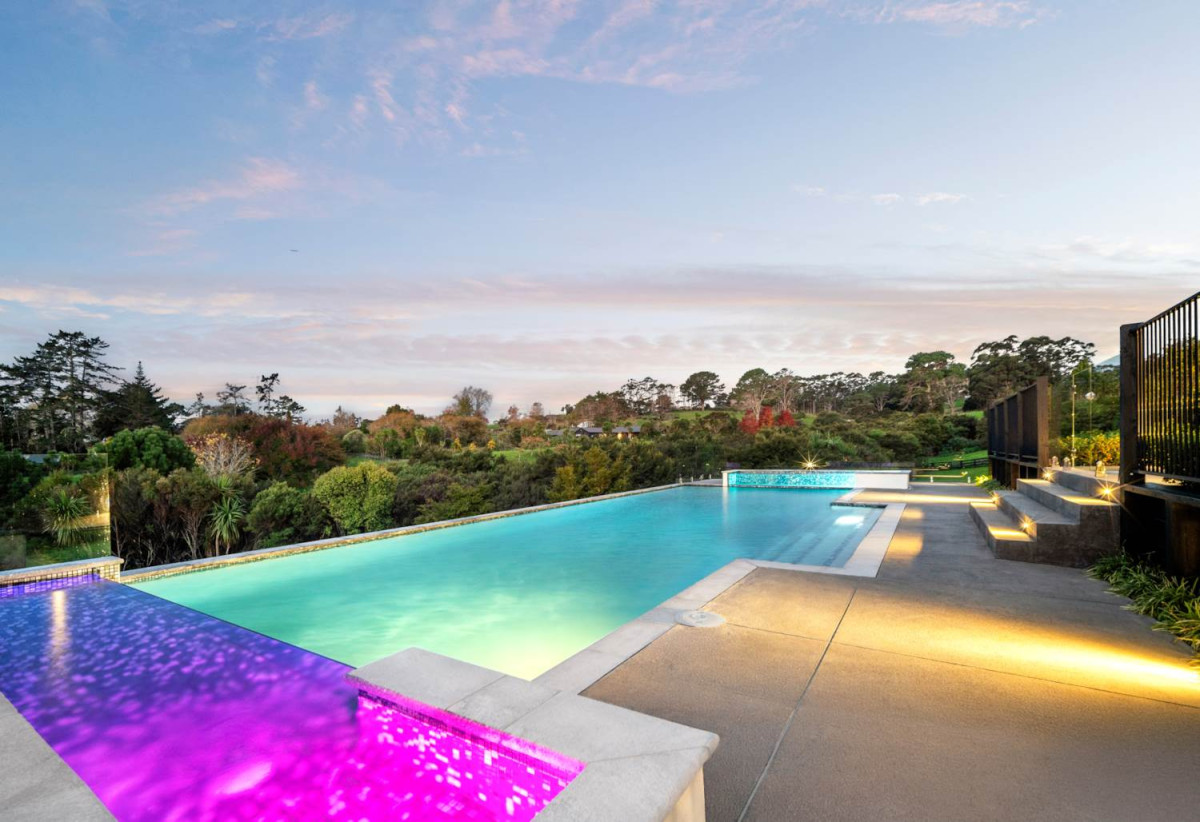 30,269m² section, The home offers 5 beds 3 baths, including a private guest suite with a designer ensuite featuring dual showers, A separate wing accommodates additional bedrooms and a luxurious family bathroom with a sculptural real stone bath, Underfloor heating throughout, A five-car garage, A formal 10-seater dining room beneath a genuine Swarovski crystal chandelier, integrated throughout the home is a premium HEOS multi-room audio system, a fully equipped private cinema with six luxury seats, The stunning 16.5-metre heated swimming pool (approx. 5.5–6m wide), 2.2 km to Riverhead School, 739 Coatesville-Riverhead Highway, Riverhead, Auckland