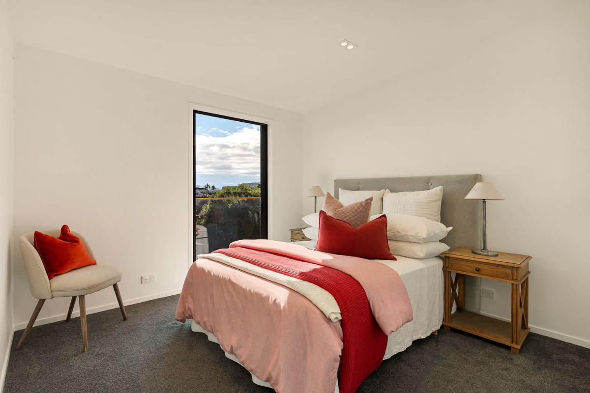 164m2 3 beds 2 baths home with double garage on 191m2 section, mature green fence lines frame the landscape, Both upstairs and downstairs bedrooms are thoughtfully positioned to embrace the water views, 118a Reihana Street, Orakei, Auckland