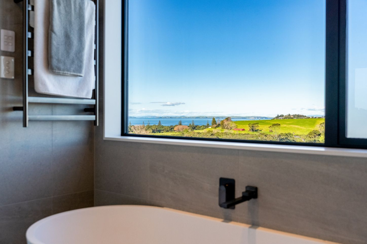 Uninterrupted sea views, 348m2 5 beds 5.5 baths house with double garage and 2-beds granny on 470m2 section, moments from Long Bay Beach and Long Bay Regional Park, shops, supermarket, schools, zoned for Long Bay College, Long Bay School, and Northcross Intermediate, 25 Kumukumu Road, Long Bay, Auckland