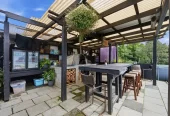 909m2 section, 158m2 4 beds 2 baths main houe PLUS a separate wing/sleepout with a 5th bedroom, bathroom, and covered deck, a massive covered patio with a professional-grade wood-fired pizza oven and a fully equipped outdoor bar area, a large carport, close to reserves, local shops, schools, 23 Tabitha Crescent Henderson, Auckland