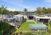 909m2 section, 158m2 4 beds 2 baths main houe PLUS a separate wing/sleepout with a 5th bedroom, bathroom, and covered deck, a massive covered patio with a professional-grade wood-fired pizza oven and a fully equipped outdoor bar area, a large carport, close to reserves, local shops, schools, 23 Tabitha Crescent Henderson, Auckland
