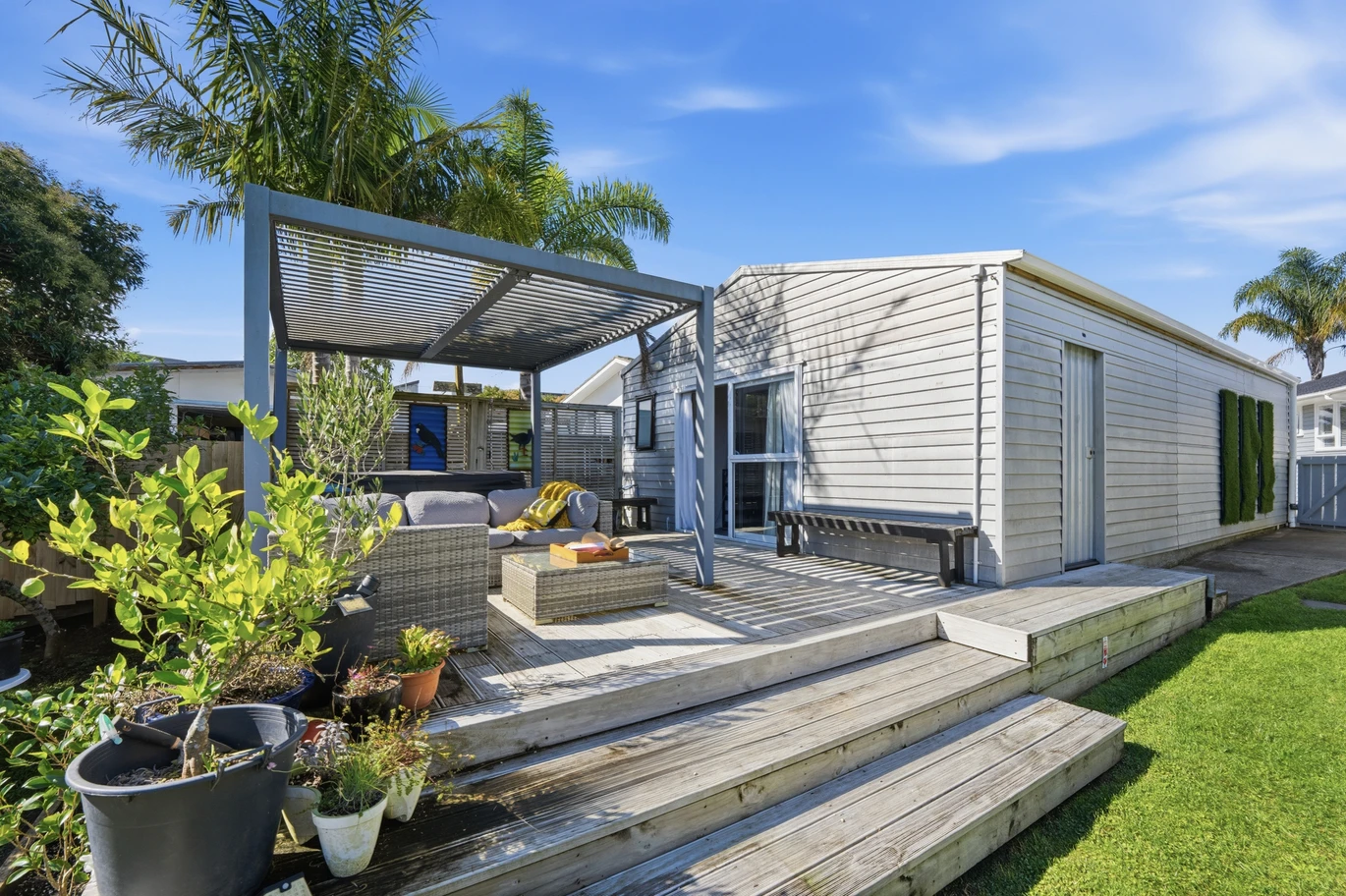 909m2 section, 158m2 4 beds 2 baths main houe PLUS a separate wing/sleepout with a 5th bedroom, bathroom, and covered deck, a massive covered patio with a professional-grade wood-fired pizza oven and a fully equipped outdoor bar area, a large carport, close to reserves, local shops, schools, 23 Tabitha Crescent Henderson, Auckland