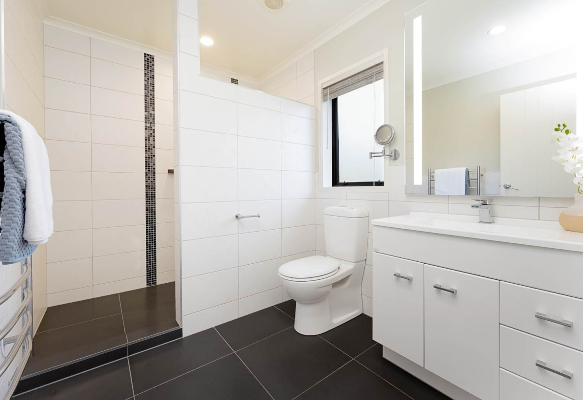 Home and income on 2502m2 section, 2 kitchens, main house 3 beds 2 baths with double garage, a private guest wing 2 beds 1 bath with its own entrance and single garage, overlooking the picturesque Torbay Heights Reserve, Approximately 10 minutes to Albany Mega Centre, close to schools, beach, 1.2 km to Long Bay School, 1.5 km to Long Bay College, 2 km to Northcross Intermediate, 349 Glenvar Road, Long Bay, Auckland