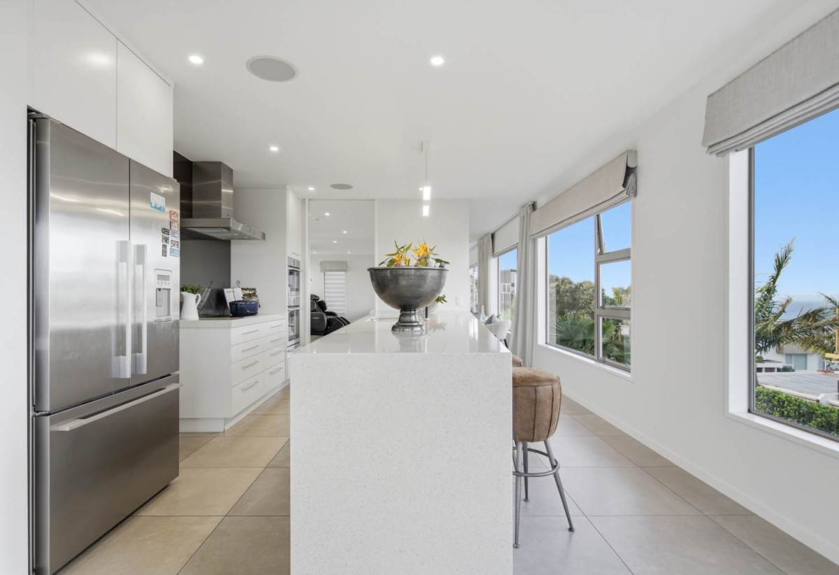 Double Westlake school zone, Breathtaking 180° Views, Sea Views, city skyline views, 640m2 section, 4 beds (2 ensuites) + large office room and rumpus room 3.5 baths house with double garage, 2024 luxury renovated, close to beach, Milford shops, schools, Zoned for Campbells Bay School, Westlake Boys’ and Westlake Girls’ High Schools, and Murrays Bay Intermediate, 62 Seaview Road, Castor Bay, Auckland