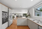 909m2 section, 158m2 4 beds 2 baths main houe PLUS a separate wing/sleepout with a 5th bedroom, bathroom, and covered deck, a massive covered patio with a professional-grade wood-fired pizza oven and a fully equipped outdoor bar area, a large carport, close to reserves, local shops, schools, 23 Tabitha Crescent Henderson, Auckland