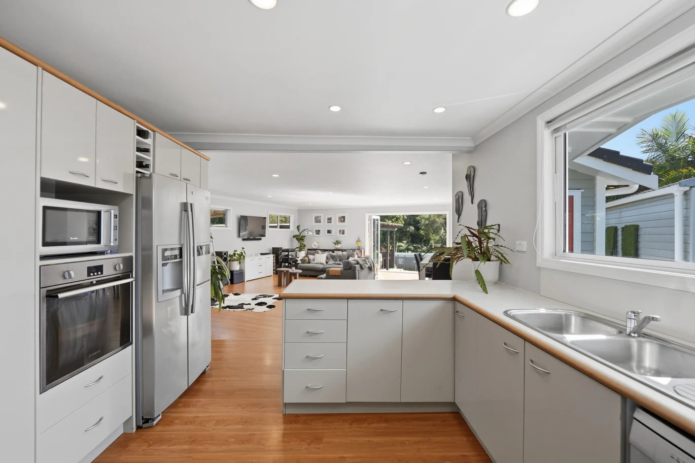 909m2 section, 158m2 4 beds 2 baths main houe PLUS a separate wing/sleepout with a 5th bedroom, bathroom, and covered deck, a massive covered patio with a professional-grade wood-fired pizza oven and a fully equipped outdoor bar area, a large carport, close to reserves, local shops, schools, 23 Tabitha Crescent Henderson, Auckland