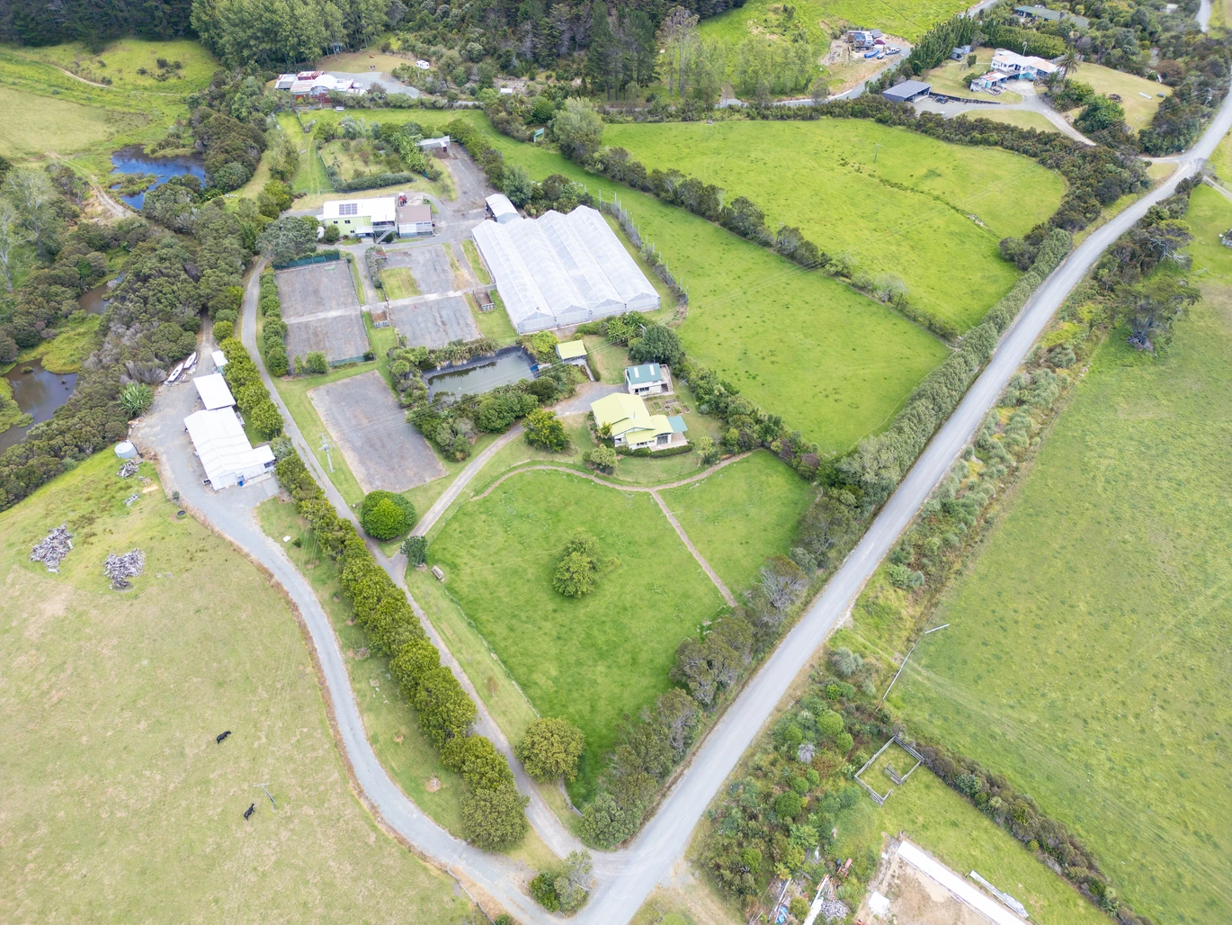 43000m2 section by the sea, LIFESTYLE, INCOME & OPPORTUNITY, Highlights include an impressive four-bay greenhouse spanning approximately 1,800sqm, a 1.2 million litre lined water reservoir, substantial workshop and packing facilities, a walk-in chiller, generous office space, and established propagation areas. a 3 beds bungalow surrounded by established cottage, A separate garage with loft accommodation, 100 Robinson Road Whangarei Heads, Whangarei District