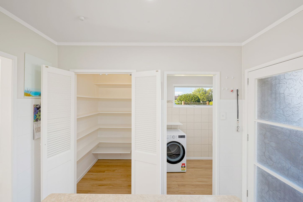 The owners are ready for a bigger home. 130m2 Brick and tile 2 beds 1 bath home with garage, 2/219 Edmonton Road, Te Atatu South, Auckland