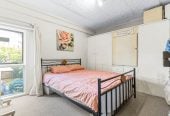 Robust construction – Concrete block and brick, 3 beds + Flexi room 2 baths home, Upstairs: 2 beds 1 bath, Separate living room with access to a sunny porch, Open-plan kitchen and dining area, Downstairs: Additional bedroom plus living area, Bathroom and utility room, 2/2B Yeoman Place, Howick, Auckland