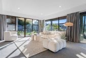 1030m2 section, Elegant Living, Sea Views & Rangitoto Zones, 6 beds (1 ensuite) + study 3.5 baths house with garage and swimming pool, A supersized entertaining lounge on the lower level, along with its own bathroom and two generous bedrooms, provides exceptional flexibility. 32 Bellbird Rise, Murrays Bay, Auckland