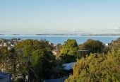 1030m2 section, Elegant Living, Sea Views & Rangitoto Zones, 6 beds (1 ensuite) + study 3.5 baths house with garage and swimming pool, A supersized entertaining lounge on the lower level, along with its own bathroom and two generous bedrooms, provides exceptional flexibility. 32 Bellbird Rise, Murrays Bay, Auckland
