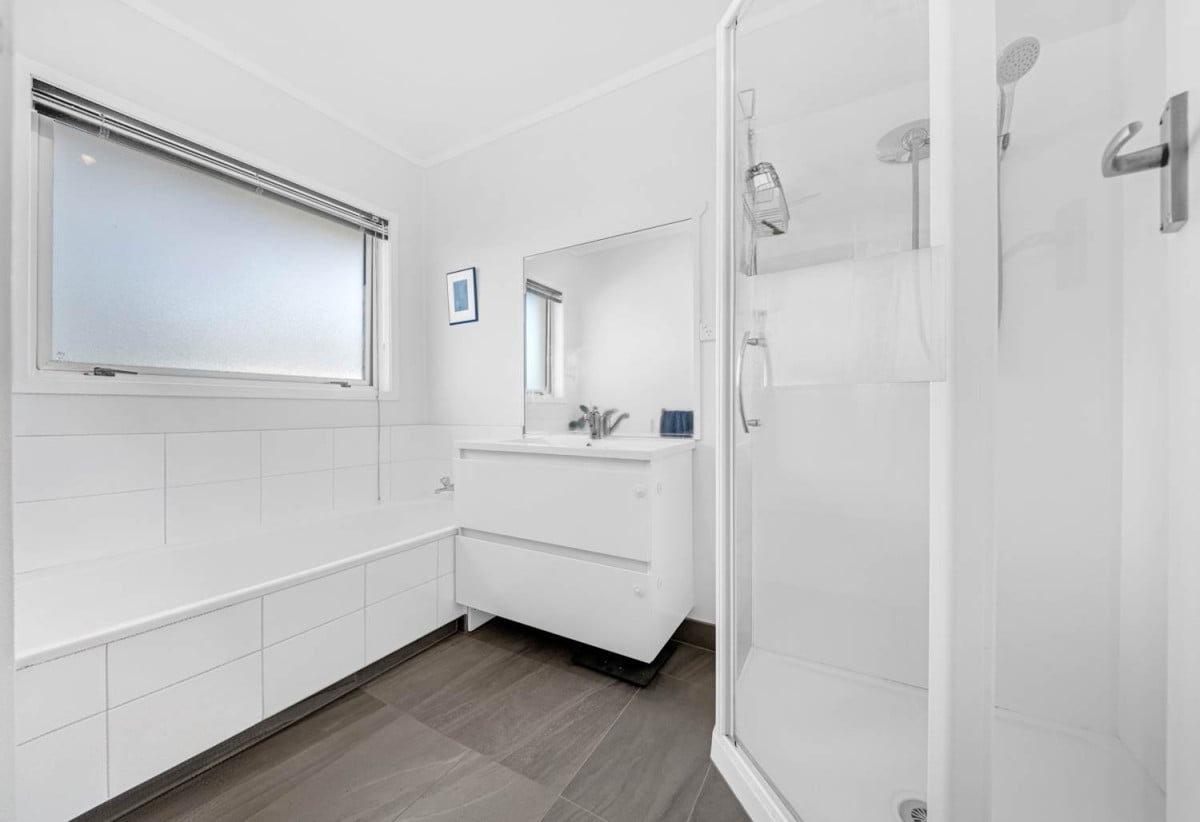 Rangitoto College zone, Brick and tile 2 beds + storage room or Flexi room (3.13 x 2.05M) 1 bath house with garage, 2/4 Noumea Place, Mairangi Bay, Auckland