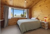 1088m2 section, 3 beds 1 bath house with carport, wooden walls and ceilings wrap around the interconnected lounge, dining area and kitchen. and Outside, the multi-level timber deck, 37A Youngs Road, Papakura, Auckland