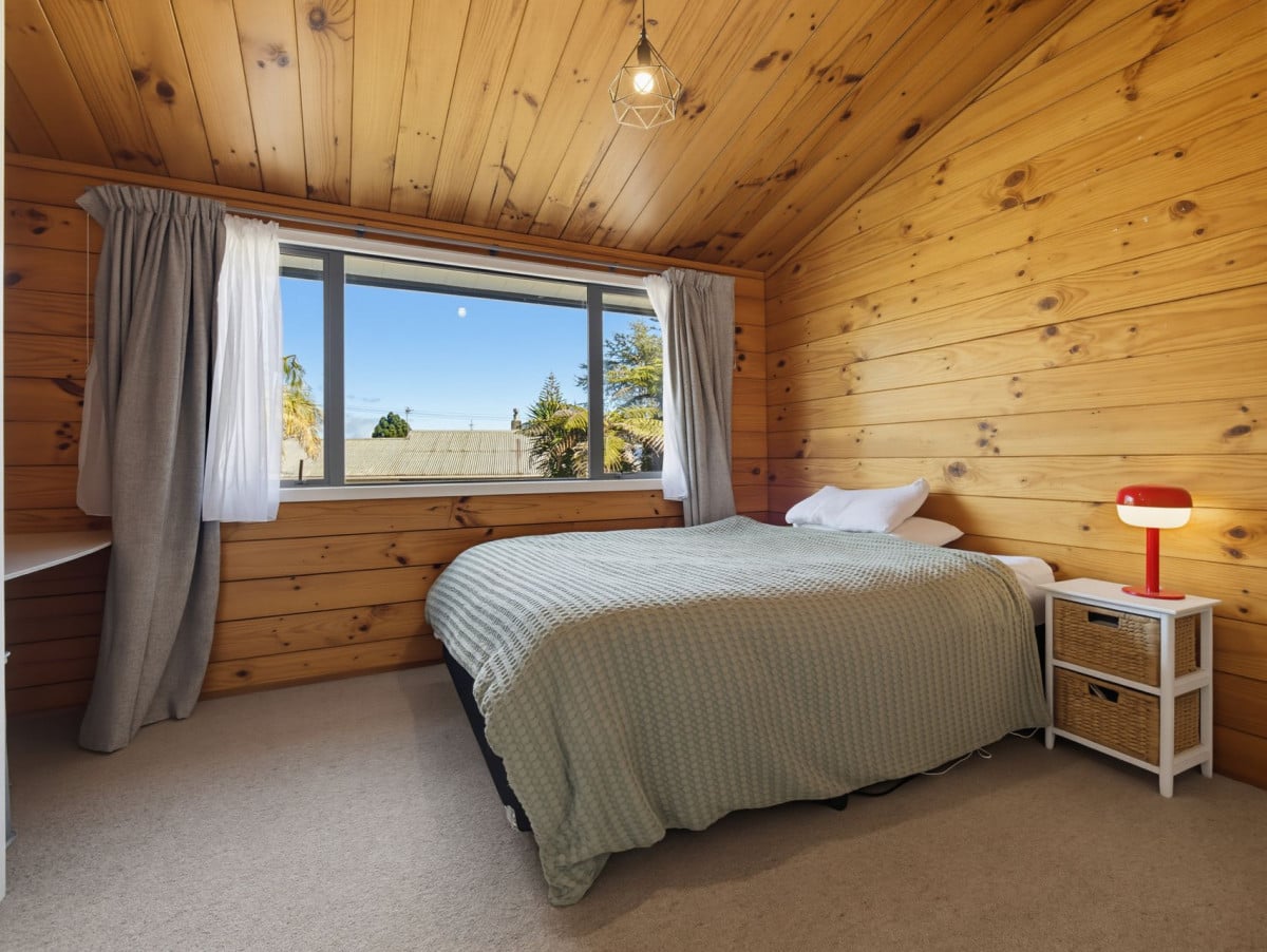 1088m2 section, 3 beds 1 bath house with carport, wooden walls and ceilings wrap around the interconnected lounge, dining area and kitchen. and Outside, the multi-level timber deck, 37A Youngs Road, Papakura, Auckland