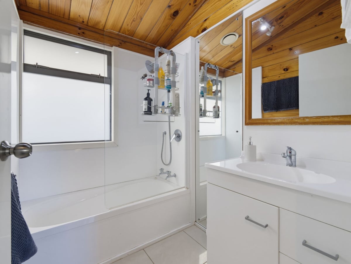 1088m2 section, 3 beds 1 bath house with carport, wooden walls and ceilings wrap around the interconnected lounge, dining area and kitchen. and Outside, the multi-level timber deck, 37A Youngs Road, Papakura, Auckland