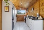 1088m2 section, 3 beds 1 bath house with carport, wooden walls and ceilings wrap around the interconnected lounge, dining area and kitchen. and Outside, the multi-level timber deck, 37A Youngs Road, Papakura, Auckland