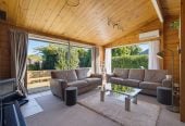 1088m2 section, 3 beds 1 bath house with carport, wooden walls and ceilings wrap around the interconnected lounge, dining area and kitchen. and Outside, the multi-level timber deck, 37A Youngs Road, Papakura, Auckland