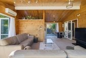 1088m2 section, 3 beds 1 bath house with carport, wooden walls and ceilings wrap around the interconnected lounge, dining area and kitchen. and Outside, the multi-level timber deck, 37A Youngs Road, Papakura, Auckland