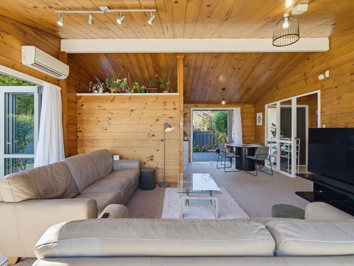 1088m2 section, 3 beds 1 bath house with carport, wooden walls and ceilings wrap around the interconnected lounge, dining area and kitchen. and Outside, the multi-level timber deck, 37A Youngs Road, Papakura, Auckland