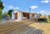 1088m2 section, 3 beds 1 bath house with carport, wooden walls and ceilings wrap around the interconnected lounge, dining area and kitchen. and Outside, the multi-level timber deck, 37A Youngs Road, Papakura, Auckland