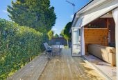 1088m2 section, 3 beds 1 bath house with carport, wooden walls and ceilings wrap around the interconnected lounge, dining area and kitchen. and Outside, the multi-level timber deck, 37A Youngs Road, Papakura, Auckland