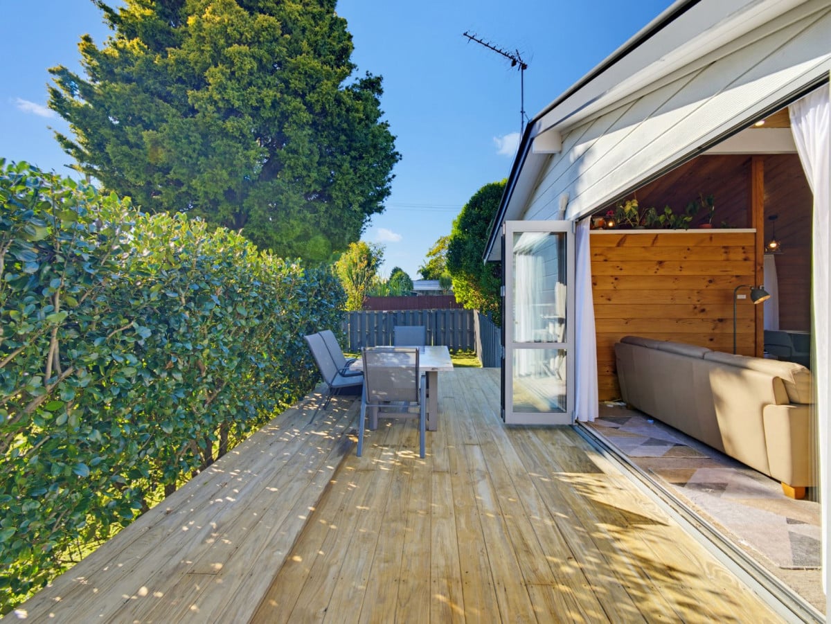1088m2 section, 3 beds 1 bath house with carport, wooden walls and ceilings wrap around the interconnected lounge, dining area and kitchen. and Outside, the multi-level timber deck, 37A Youngs Road, Papakura, Auckland