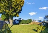 1088m2 section, 3 beds 1 bath house with carport, wooden walls and ceilings wrap around the interconnected lounge, dining area and kitchen. and Outside, the multi-level timber deck, 37A Youngs Road, Papakura, Auckland