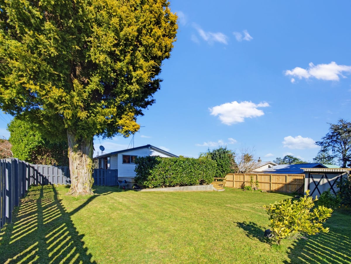 1088m2 section, 3 beds 1 bath house with carport, wooden walls and ceilings wrap around the interconnected lounge, dining area and kitchen. and Outside, the multi-level timber deck, 37A Youngs Road, Papakura, Auckland