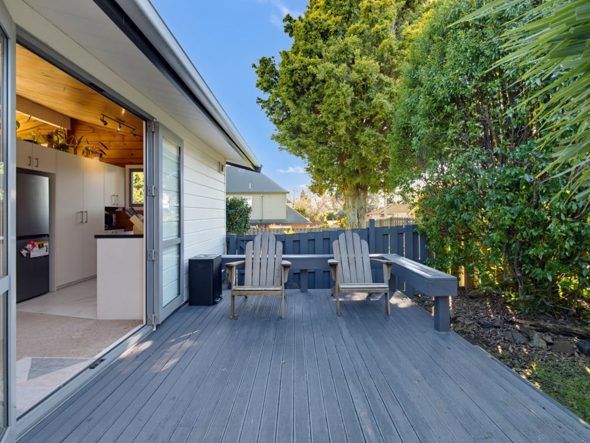1088m2 section, 3 beds 1 bath house with carport, wooden walls and ceilings wrap around the interconnected lounge, dining area and kitchen. and Outside, the multi-level timber deck, 37A Youngs Road, Papakura, Auckland