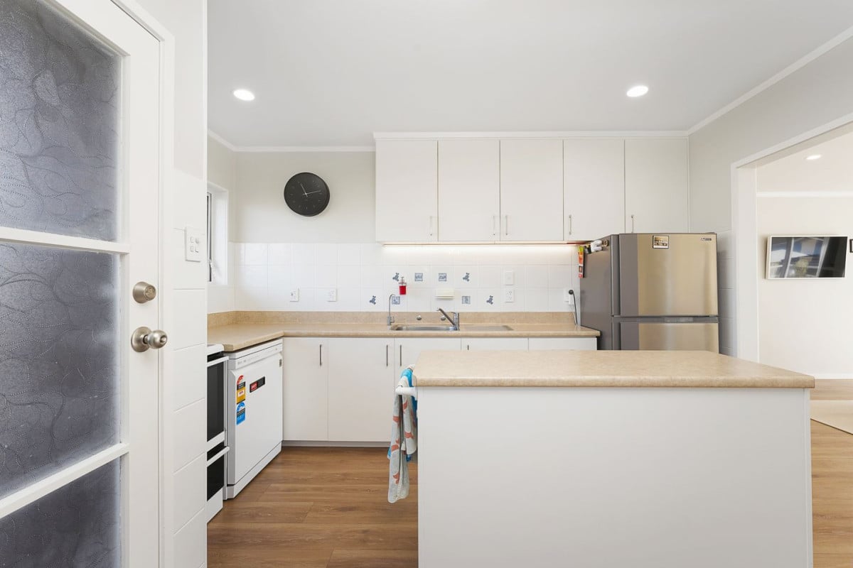The owners are ready for a bigger home. 130m2 Brick and tile 2 beds 1 bath home with garage, 2/219 Edmonton Road, Te Atatu South, Auckland