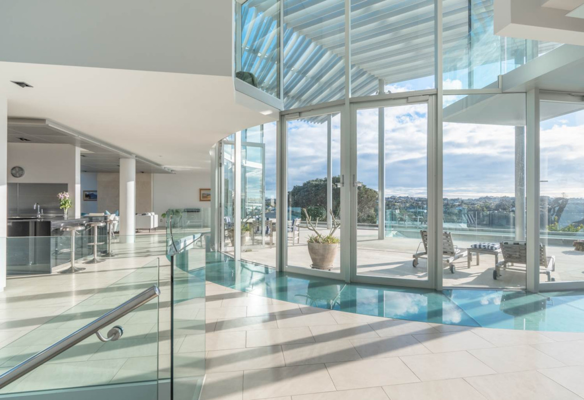 Just 160 metres from Waiake Beach, 1948m2 section, Built-in lift, 5 beds (5 ensuites) + office and wine room 6.5 baths house with 4 garage and the 18-metre cantilevered lap pool, 4 Sharon Road, Waiake, Auckland