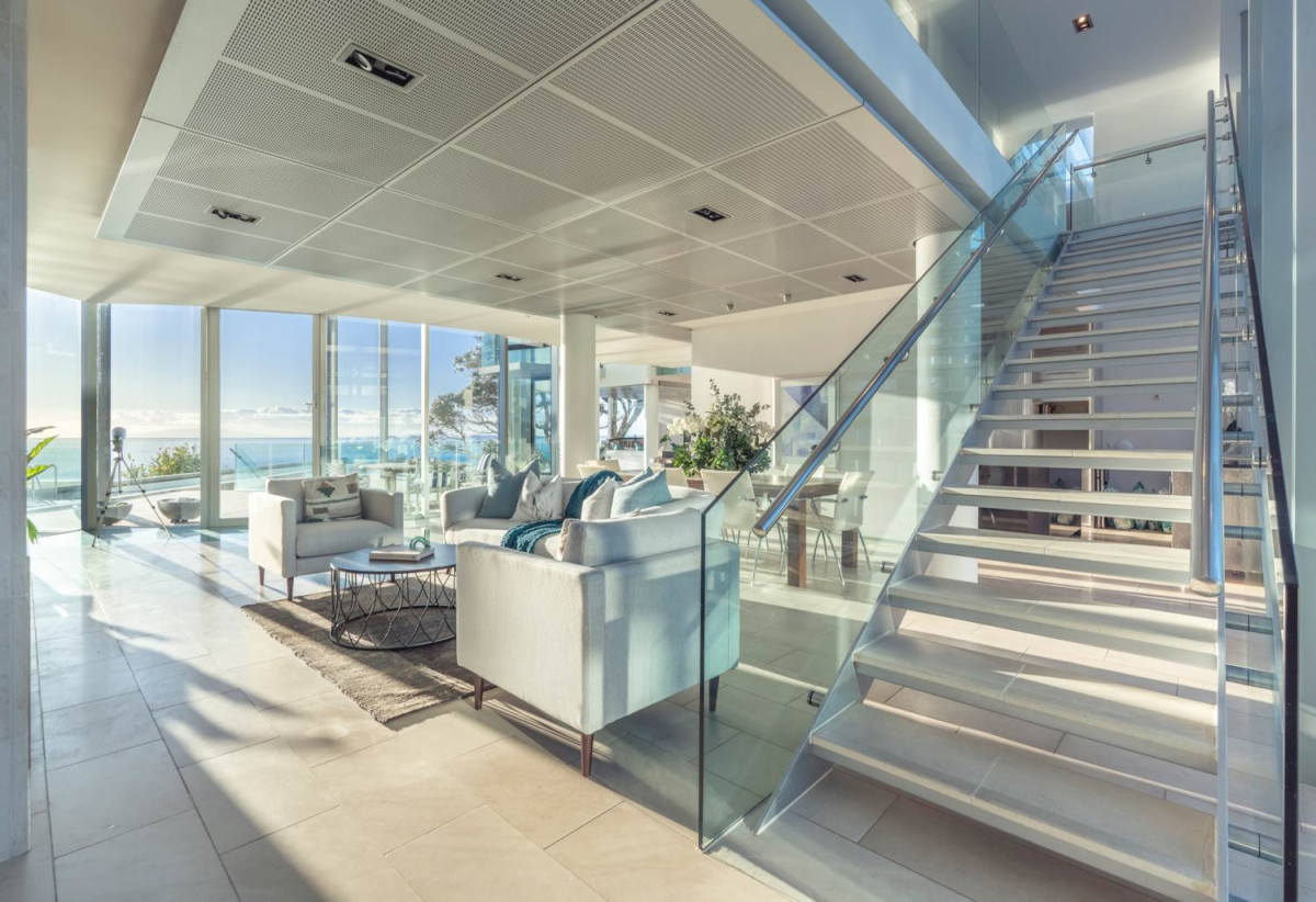 Just 160 metres from Waiake Beach, 1948m2 section, Built-in lift, 5 beds (5 ensuites) + office and wine room 6.5 baths house with 4 garage and the 18-metre cantilevered lap pool, 4 Sharon Road, Waiake, Auckland