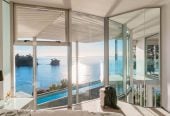 Just 160 metres from Waiake Beach, 1948m2 section, Built-in lift, 5 beds (5 ensuites) + office and wine room 6.5 baths house with 4 garage and the 18-metre cantilevered lap pool, 4 Sharon Road, Waiake, Auckland